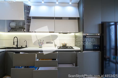 Image of Luxury white and dark grey modern kitchen interior, front view
