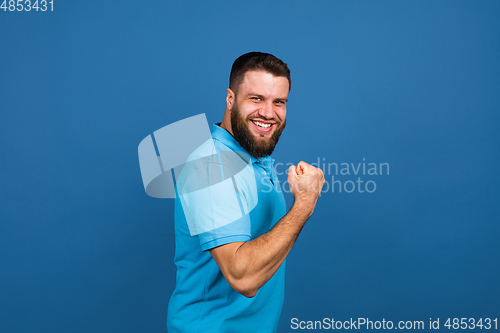 Image of Caucasian man\'s portrait isolated on blue studio background with copyspace