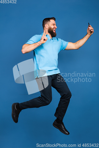 Image of Caucasian man\'s portrait isolated on blue studio background with copyspace