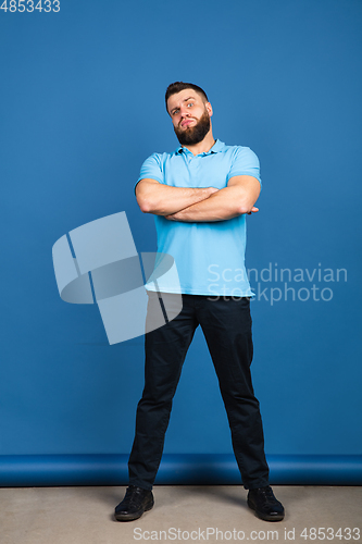 Image of Caucasian man\'s portrait isolated on blue studio background with copyspace