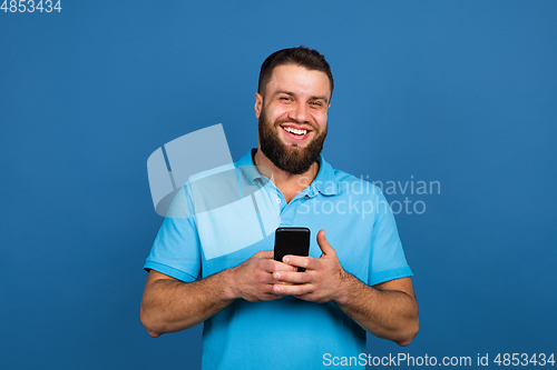 Image of Caucasian man\'s portrait isolated on blue studio background with copyspace