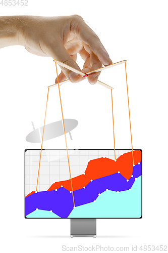 Image of Businessman keeping the growth in economy, manipulating graphs like puppet