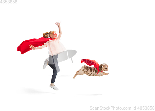 Image of Child pretending to be a superhero with her super dog isolated on white studio background