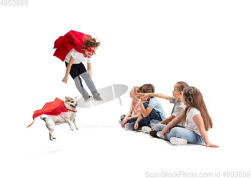 Image of Child pretending to be a superhero with his super dog and friends sitting around