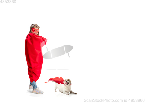 Image of Child pretending to be a superhero with her super dog isolated on white studio background