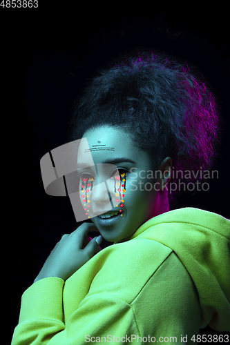 Image of Tears illustrated of social media activity signs on female face in neon light. Real life versus online lifestyle, addiction to modern technologies