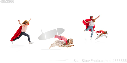 Image of Children pretending to be a superhero with their super dog isolated on white studio background