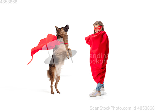 Image of Child pretending to be a superhero with her super dog isolated on white studio background