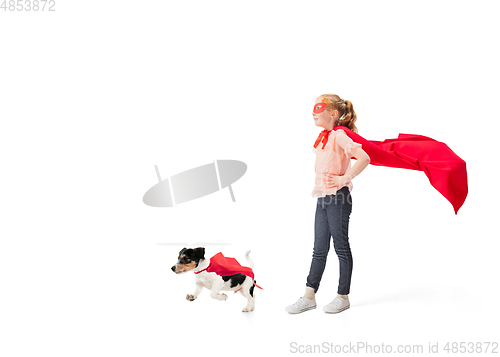 Image of Child pretending to be a superhero with her super dog isolated on white studio background