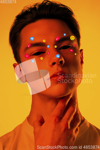 Image of Tears illustrated of social media activity signs on male face in neon light. Real life versus online lifestyle, addiction to modern technologies