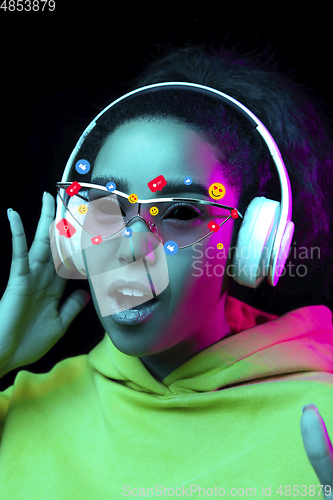 Image of Tears illustrated of social media activity signs on female face in neon light. Real life versus online lifestyle, addiction to modern technologies