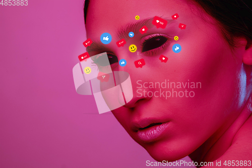 Image of Tears illustrated of social media activity signs on female face in neon light. Real life versus online lifestyle, addiction to modern technologies