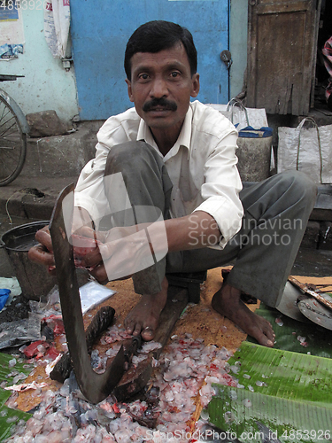 Image of Man selling fish at a street market in Kolkata, West Bengal, India