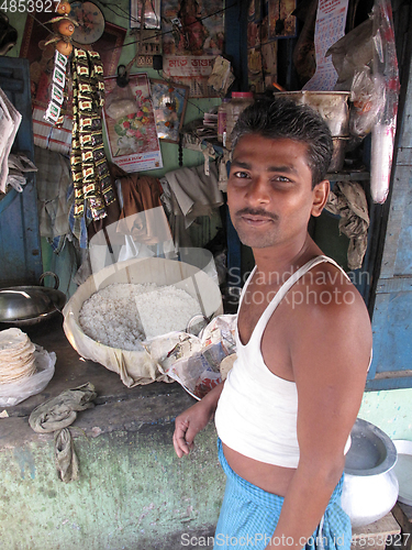 Image of Man cooking on the street in Kolkata, West Bengal, India 