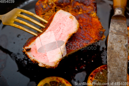 Image of pork chop seared on iron skillet
