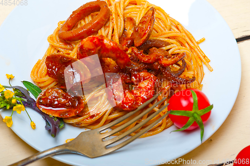 Image of Italian seafood spaghetti pasta on red tomato sauce