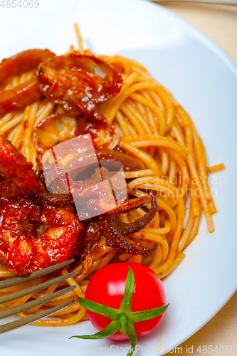 Image of Italian seafood spaghetti pasta on red tomato sauce