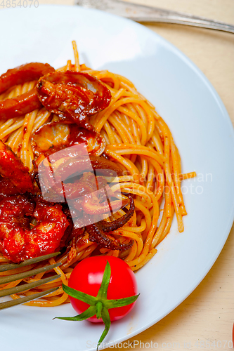 Image of Italian seafood spaghetti pasta on red tomato sauce