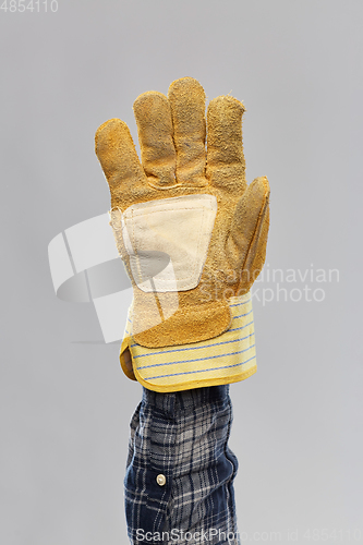 Image of builder's hand in protective leather glove