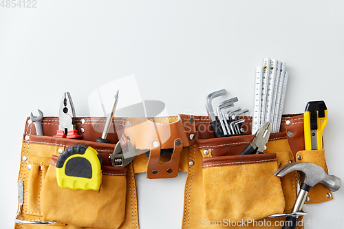 Image of different work tools in belt on white background