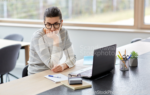 Image of bored woman with laptop working at home office