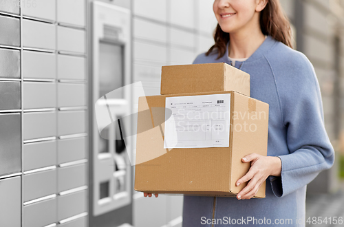 Image of woman with boxes at automated parcel machine