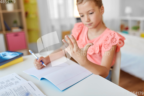 Image of student girl with notebook counting fingers