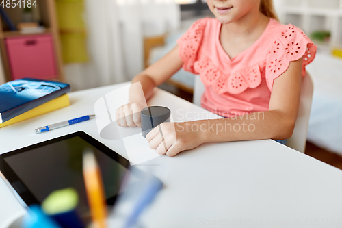 Image of student girl using smart speaker at home