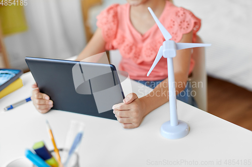 Image of student girl with tablet pc and wind turbine