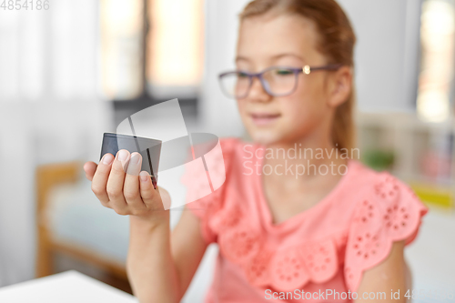 Image of student girl using smart speaker at home