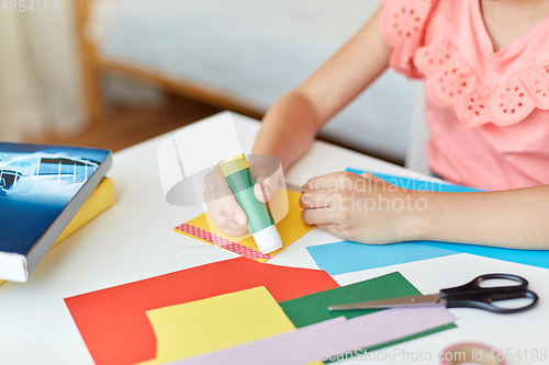 Image of creative girl making greeting card at home