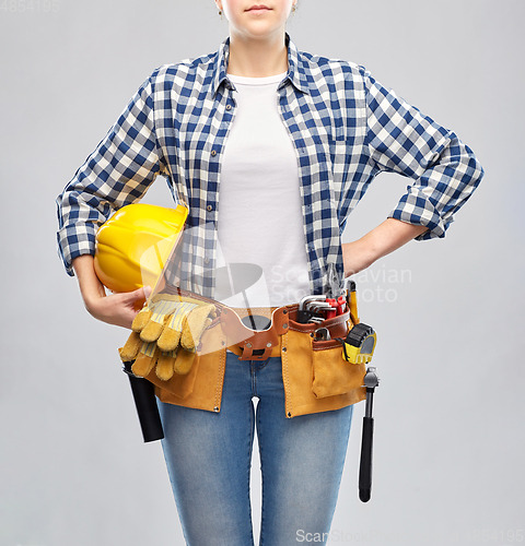 Image of woman or builder with helmet and working tools