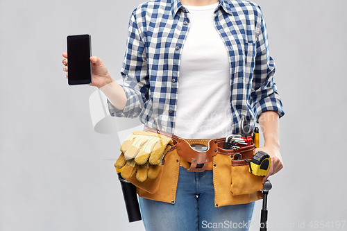 Image of woman or builder with phone and working tools