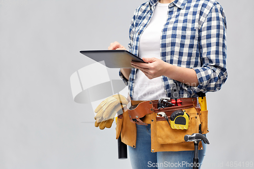 Image of woman or builder with tablet pc and working tools