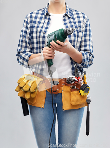 Image of woman or builder with drill and work tools