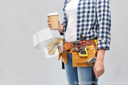 Image of woman with takeaway coffee cup and working tools