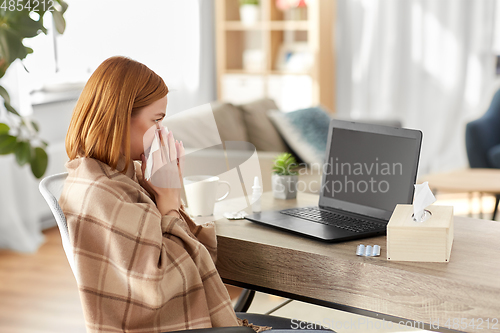 Image of sick woman having video call on laptop at home