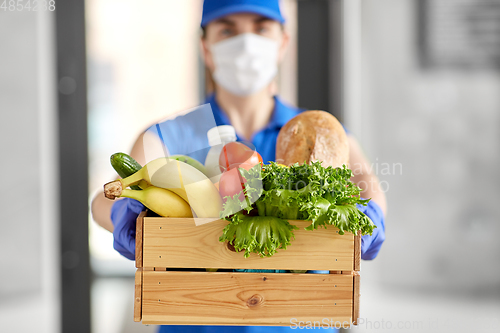 Image of delivery woman in face mask with food in box