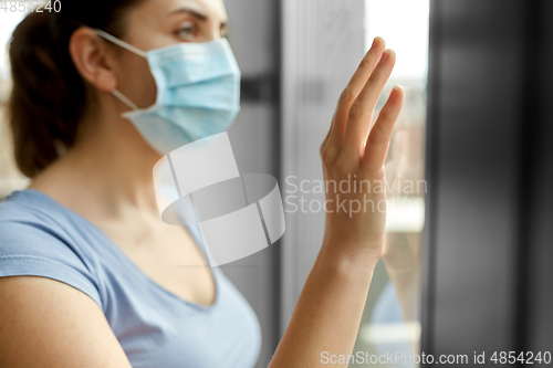 Image of sick young woman wearing protective medical mask