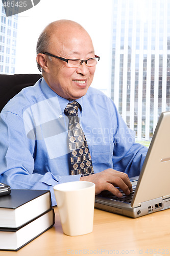 Image of Working senior asian businessman