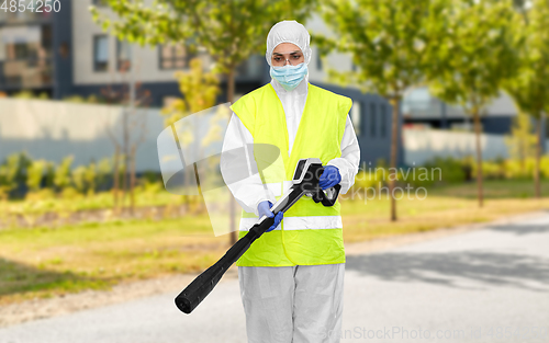 Image of sanitation worker in hazmat with pressure washer