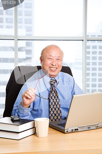 Image of Working senior asian businessman