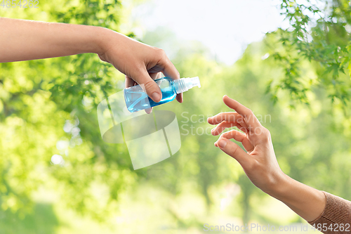 Image of close up of hands giving each other gel sanitizer