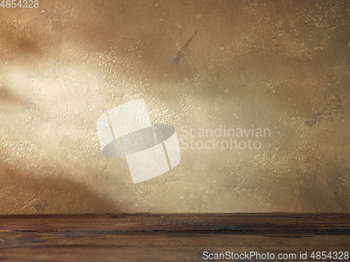 Image of beige wall and wooden shelf