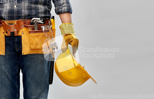 Image of worker or builder with helmet and working tools