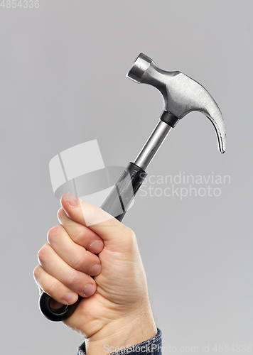 Image of close up of builder's hand holding hammer