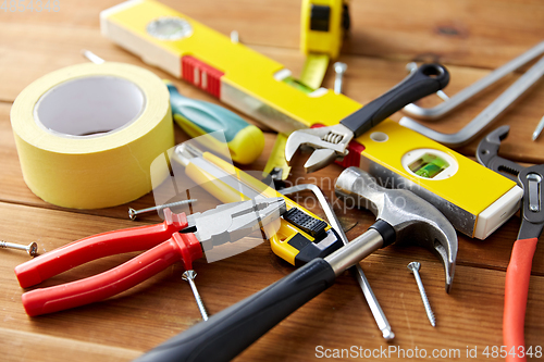 Image of different work tools on wooden boards background