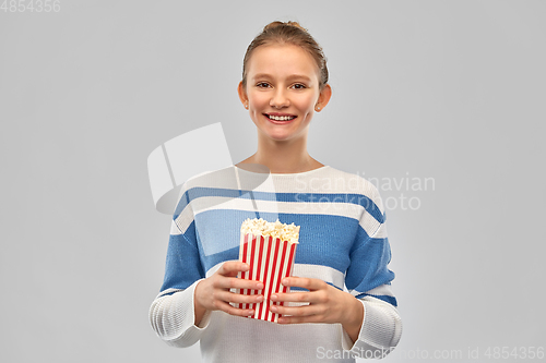 Image of smiling teenage girl with popcorn
