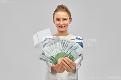 Image of smiling teenage girl with euro money banknotes