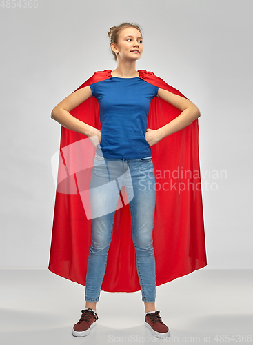 Image of smiling teenage girl in red superhero cape